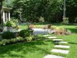 Rear dining terrace set in backyard landscape close to Hunting Valley Ohio